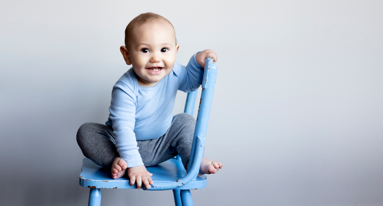 one year old boy on blue chair